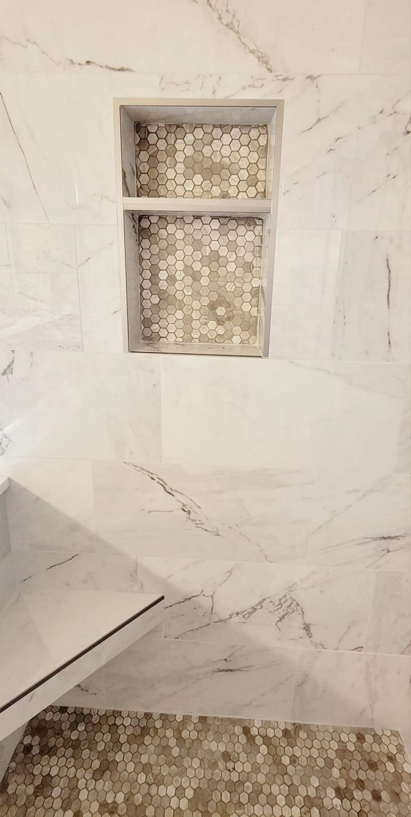 McKinney bathroom remodel: marble shower with hex-mosaic double niche