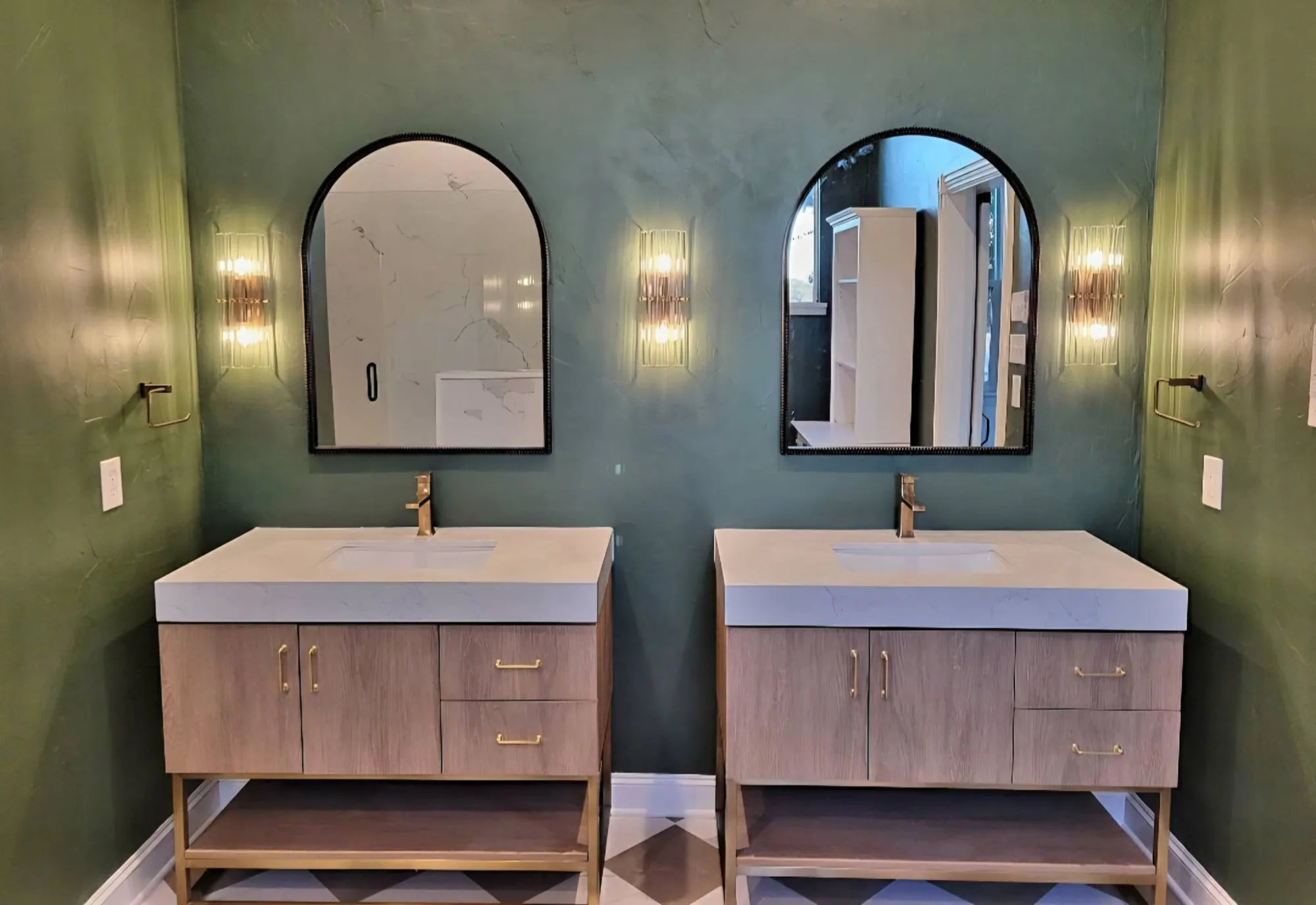 Primary bath remodel with dual arched mirrors and brass double vanity