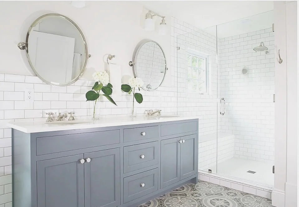 Double-vanity primary bath remodel with frameless glass shower