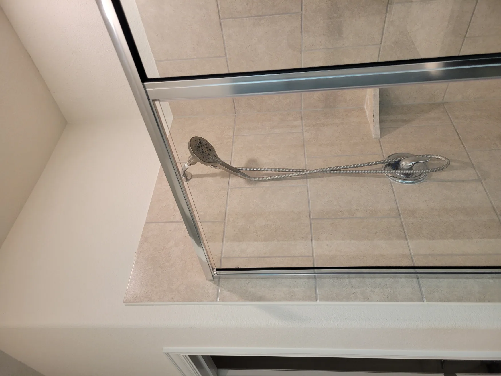 Handheld shower detail on a rebuilt tile shower
